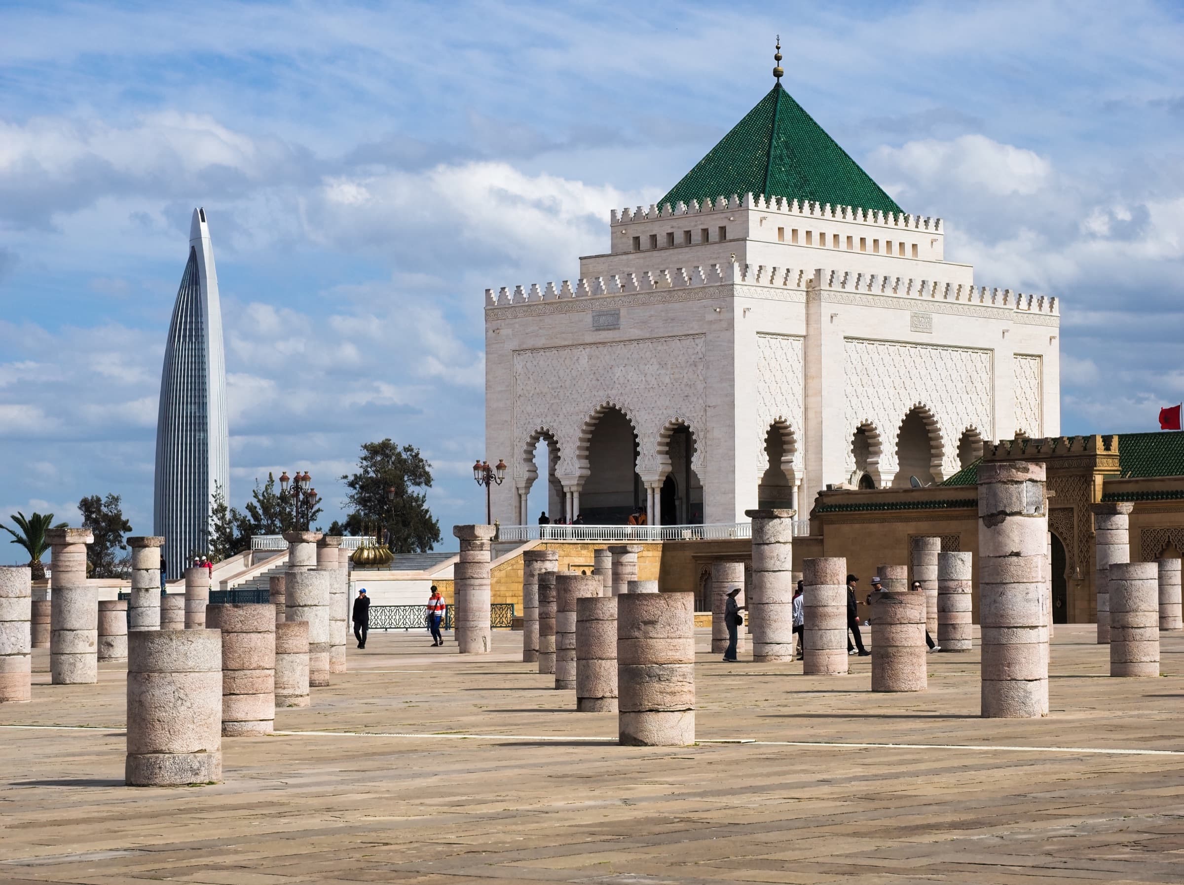 The Mausoleum of Mohammed V in Rabat, with its green tiled roof, the Mohammed VI Tower rising behind it